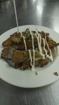 Drizzling Creamy Mayonnaise Over Parmesan Potato Wedges - Vertical Video