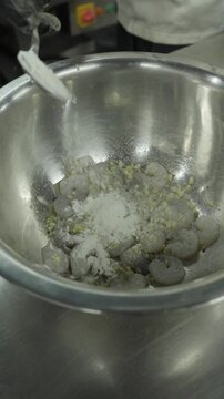 Chef Adding Cornstarch Flour to Marinated Prawns - Vertical Video