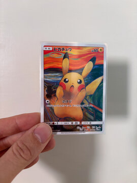 Hamburg, Germany - 09052026: male hand holding fake Pikachu Munch Exhibition PROMO card, fan made paper trading card.