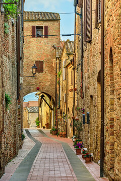 An empty alley features traditional houses in Casole d' Elsa