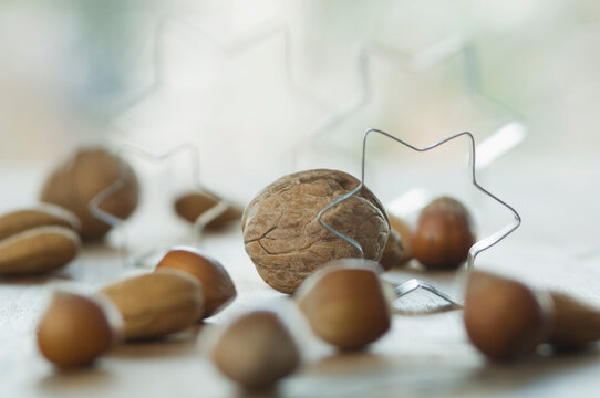 Various nuts with cookie cutter on table