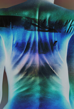 A woman displays her back with a surreal inverted infrared effect