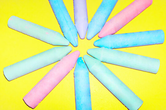 Colourful chalk forms a circle on a yellow background