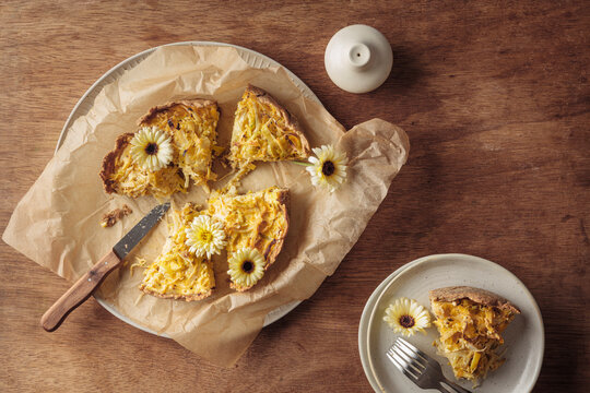 A gluten free white cabbage quiche sits on a wooden table