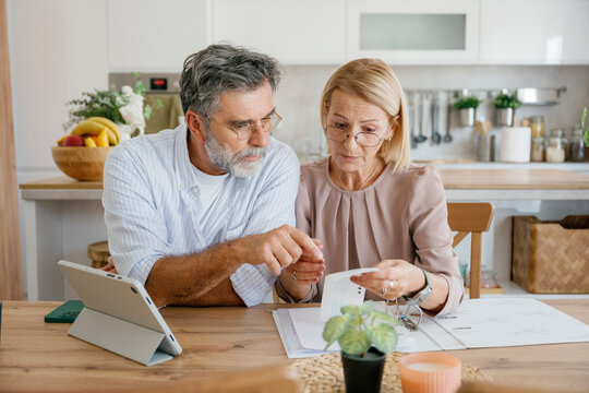 Couple discussing bills and finances together at home