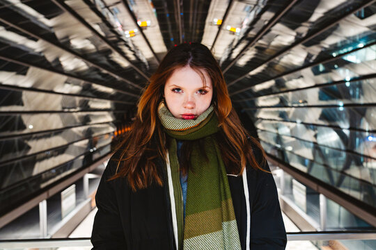 Confident youth with bold gaze in urban modern architecture in Hamburg