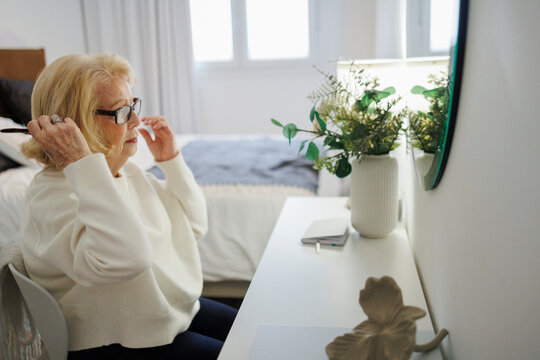 Smiling person relaxing and reading indoors by a mirror in a cozy home