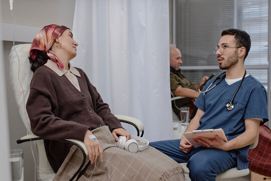 Doctor talking with patient during chemotherapy infusion support