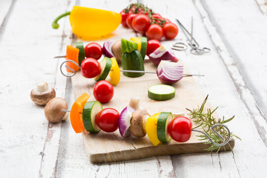 Vegetarian grill spits, orange and yellow paprika, tomato, red onion, zucchini and champignons