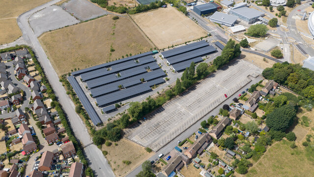 Aerial view shows solar carports in a large parking lot