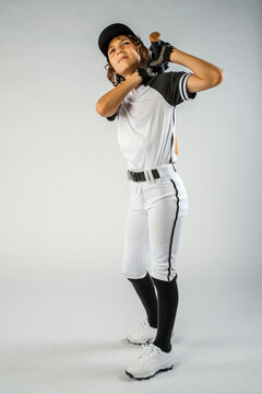 Young male baseball player with bat, watching the fly ball after hitting it deep