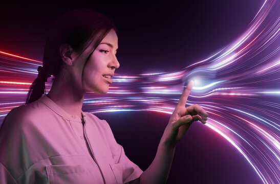 Woman touching glowing digital data stream in modern office