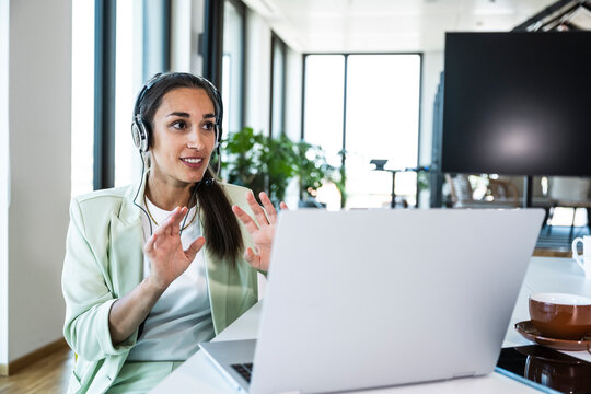 Businesswoman with headset talking on video call in the office