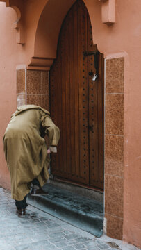 Man in Traditional Djellaba Robe at Moroccan Doorway