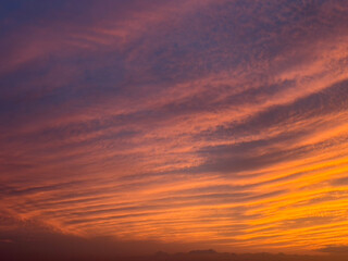 Fototapeta premium Dramatic Orange and Purple Sunset Sky with Colorful Clouds and Copy Space