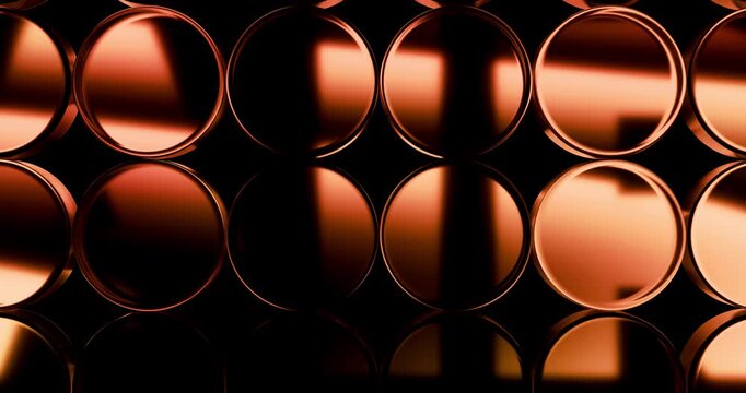 Abstract pattern of copper metal cylinders with glowing light reflections moving across circular surface