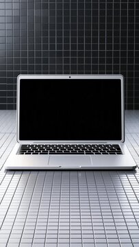 Modern silver laptop computer open with a blank screen displayed on with grid pattern and copy space for design elements and content creation applications business office