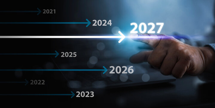 Year 2027 Strategic Planning Concept with Hand Touching Futuristic Digital Timeline.
