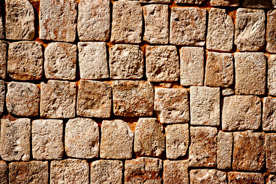 Texture of stone wall of historic Mayan pyramids in Uxmal, Mexico
