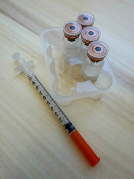 Reta, retatrutide peptide in a vial and bacteriostatic water on a wooden background