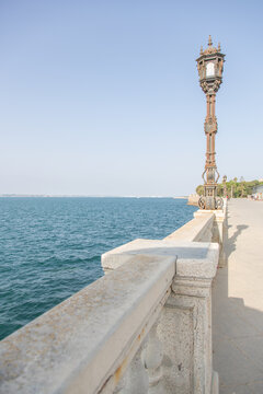 Historic street lamp at the sea promenade of C&aacute;diz, Spain