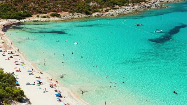 Saleccia Beach Corsica France 70mm drone view turquoise sea pine trees umbrellas sailing boats yachts bay overview Agriates desert travel destination 4k video