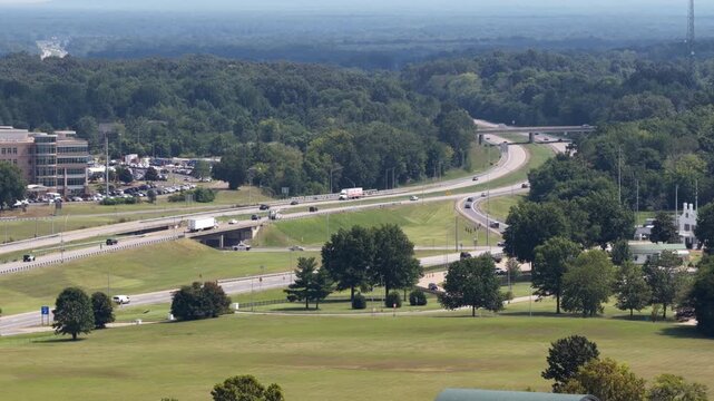 Aerial of interstate 24 interchange in Paducah Kentucky in wooded countryside with suburban development