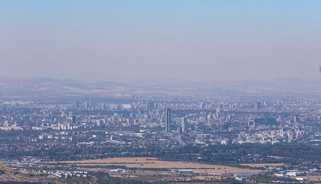 Panoramic aerial view of a large city skyline with modern skyscrapers and urban sprawl