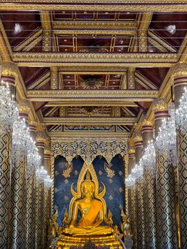 Interior view of the magnificent golden Buddha statue Phra Phuttha Chinnarat inside the traditional Thai temple in Phitsanulok, Thailand.