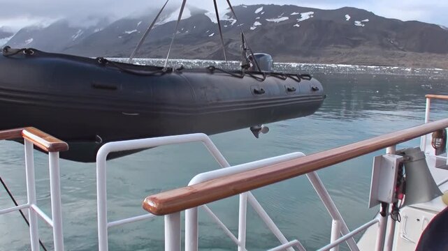 An expedition ship sails across the Arctic Ocean near a distant glacier, with cold water and the frozen northern landscape providing clear scale. The source identifies the location near Norway.
