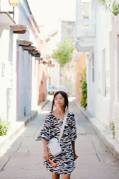 Young girl exploring vibrant street in historic cartagena