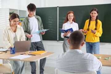 Teenage students doing presentation of their school project in classroom