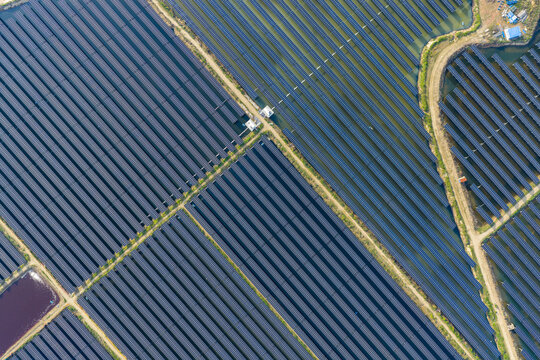 vast floating solar farm and wind turbines over water