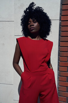Confident woman poses on city street during daytime