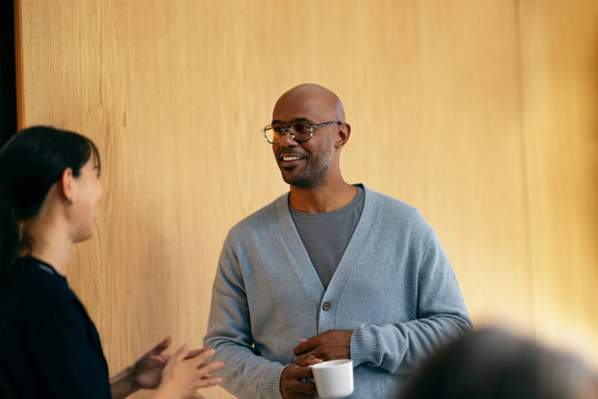 Colleagues Chatting Over Coffee in Office