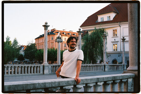 Man smiling on triple bridge in Ljubljana