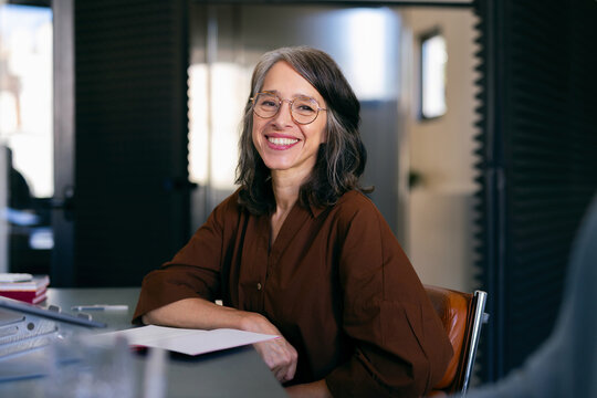 Smiling Businesswoman in Modern Office, a Portrait