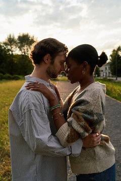 Couple shared moment at sunset in a park