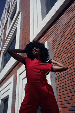 Fashion portrait of woman against contemporary architecture