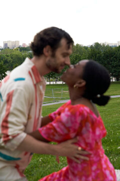 Couple shares a moment in a park during sunset