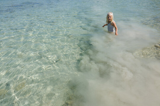Child stands in white silt clouds