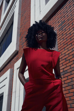 Fashion portrait of woman against contemporary architecture