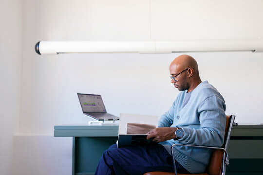 Businessman Reading Report in Minimal Modern Office