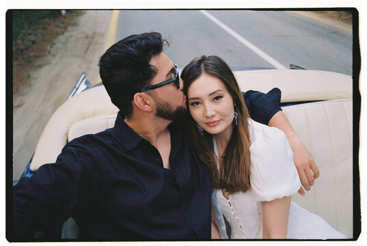 Couple Riding in Vintage Blue Convertible