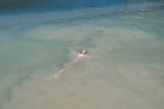 Child swimming in white silt clouds