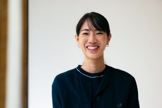 Smiling Young Professional Woman Looking at Camera