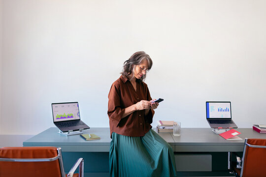 Businesswoman Using Smartphone in Modern Office