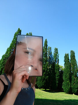 Girl looking at camera through a lenticular magnifying lens
