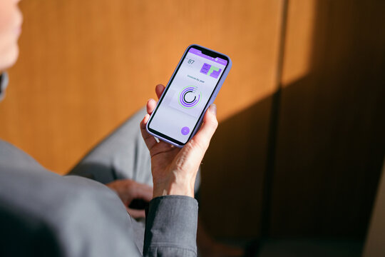 Businesswoman Viewing Analytics App On Smartphone Screen