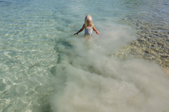 Child stands in white silt clouds